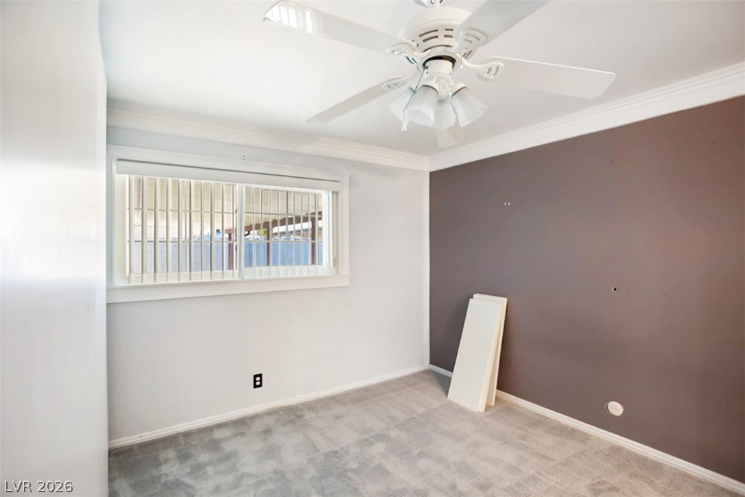 228 Redstone Street Las Vegas, NV 89145 - Photo 13 of 31 Carpeted spare room with ornamental molding and a ceiling fan