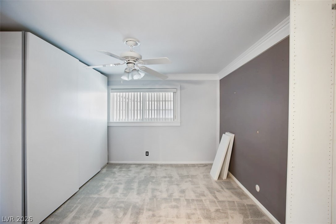 228 Redstone Street Las Vegas, NV 89145 - Photo 14 of 31 Spare room with ceiling fan, carpet flooring, and crown molding