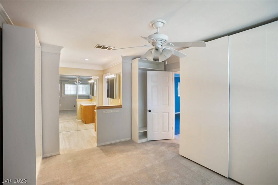 228 Redstone Street Las Vegas, NV 89145 - Photo 16 of 31 Unfurnished bedroom featuring ornamental molding, light colored carpet, a ceiling fan, and recessed lighting
