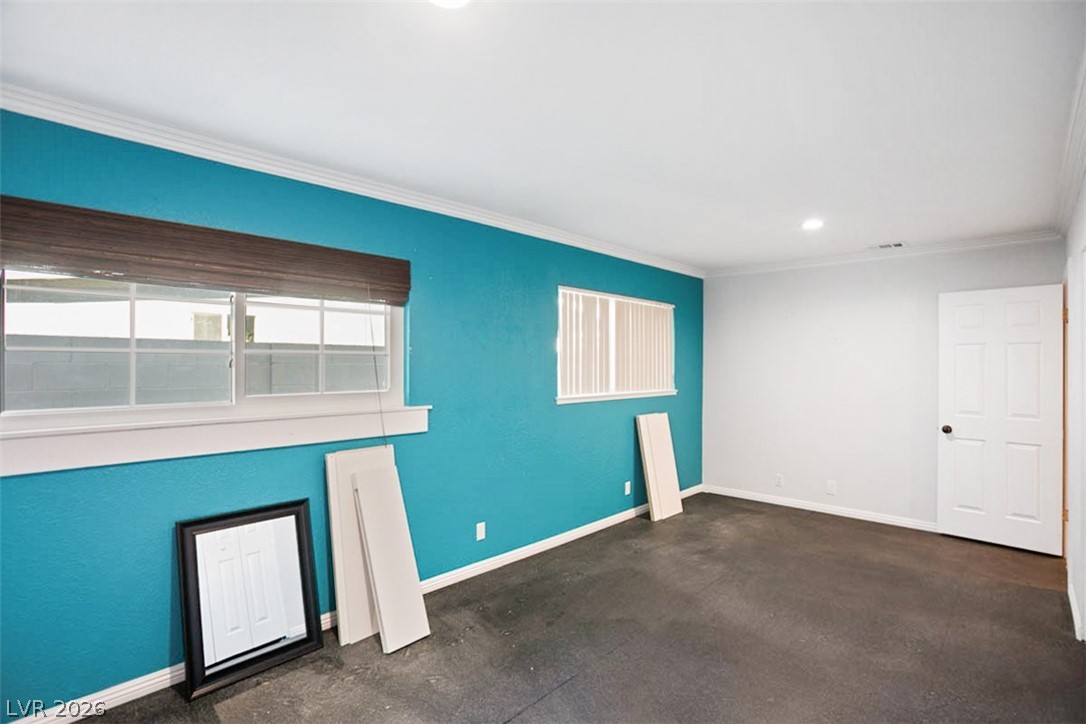 228 Redstone Street Las Vegas, NV 89145 - Photo 19 of 31 Empty room with ornamental molding and recessed lighting