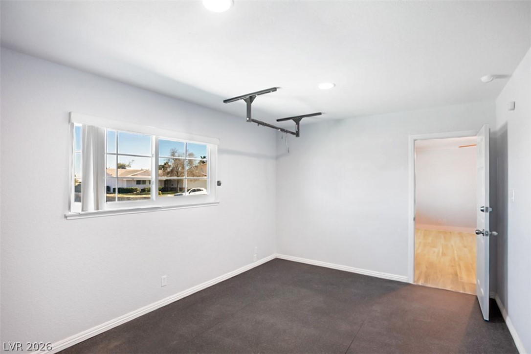 228 Redstone Street Las Vegas, NV 89145 - Photo 24 of 31 Empty room featuring dark carpet and recessed lighting