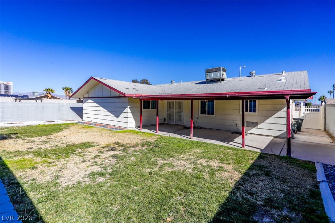 228 Redstone Street Las Vegas, NV 89145 - Photo 29 of 31 Back of property with a fenced backyard and a patio