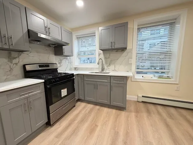 a kitchen with stainless steel appliances a stove sink and cabinets