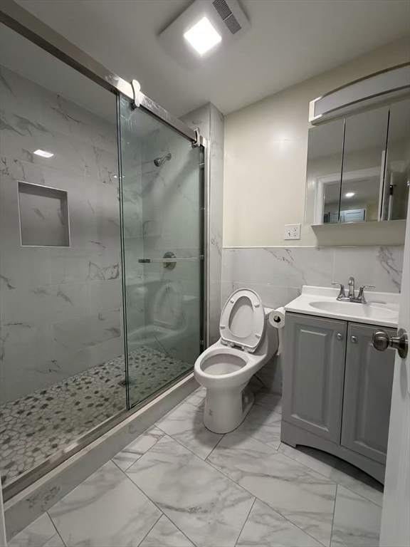 17 Hudson Street, Unit 2 Boston, MA 02111 - Photo 2 of 6 a bathroom with a toilet sink and shower