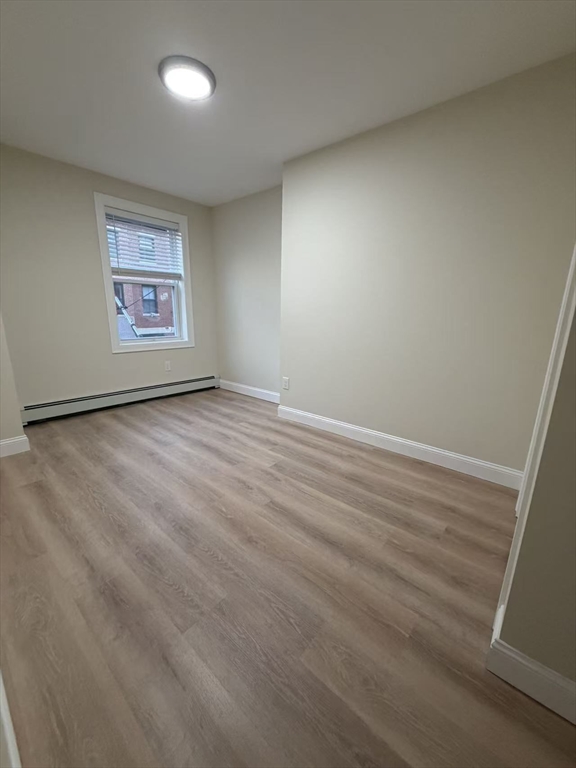 17 Hudson Street, Unit 2 Boston, MA 02111 - Photo 5 of 6 an empty room with a workbench