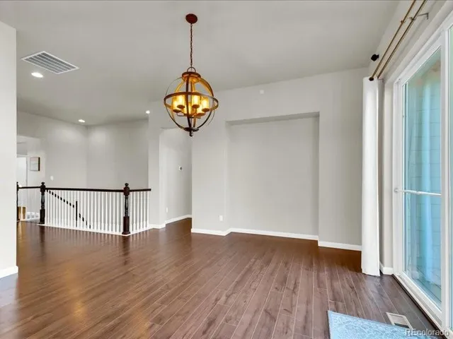 a large kitchen with stainless steel appliances kitchen island granite countertop a stove a sink and a microwave