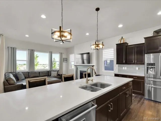 a living room with furniture flat screen tv and a fireplace
