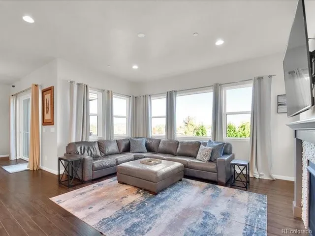 a living room kitchen with a couch and a view of kitchen appliances