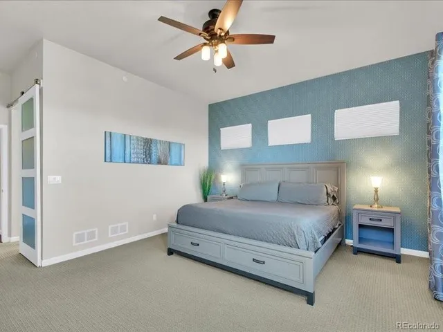 a bedroom with furniture and a flat screen tv