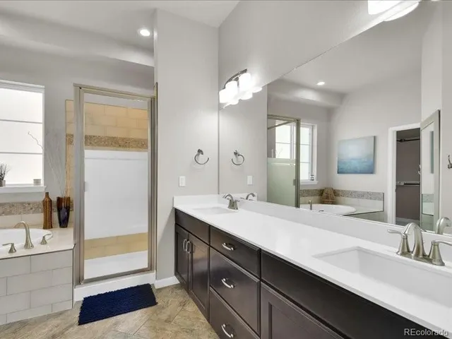 a bathroom with a tub and large window