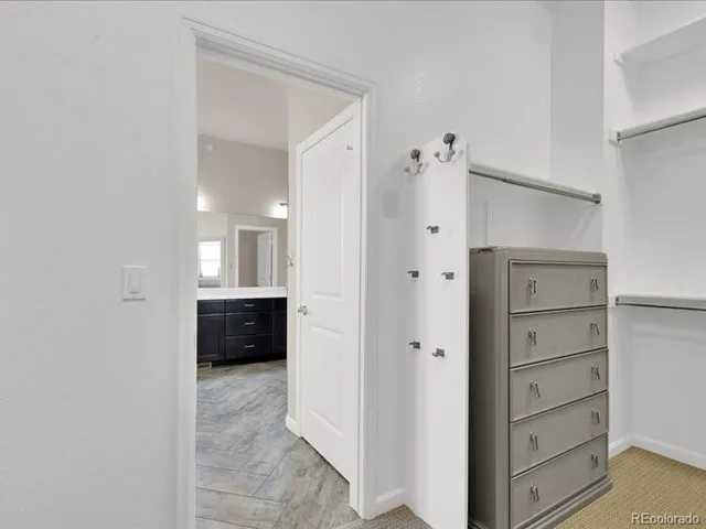 a view of staircase with wooden floor and white walls