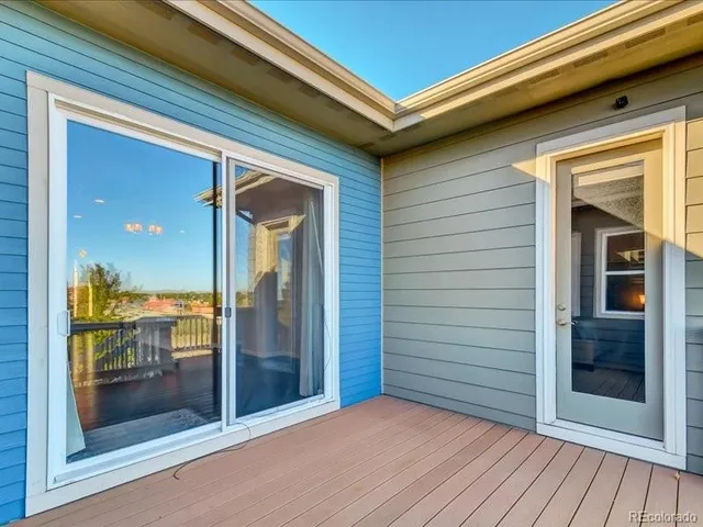 a view of front door and porch with wooden floor