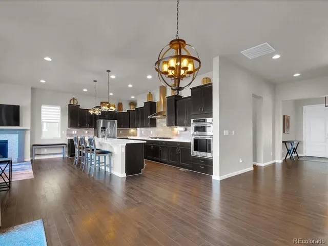 a view of room with wooden floor and chandelier