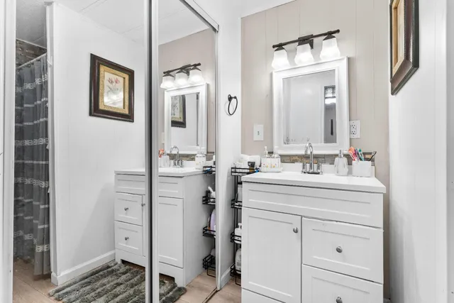 a bathroom with a sink a vanity and a mirror