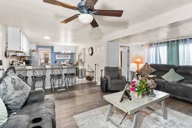 a living room with furniture and kitchen view