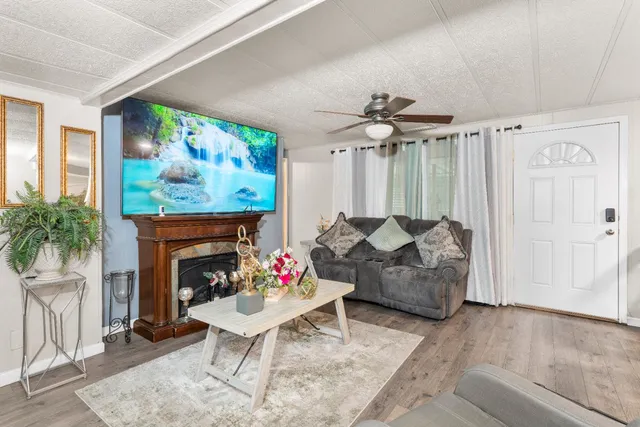 a living room with furniture and a fireplace