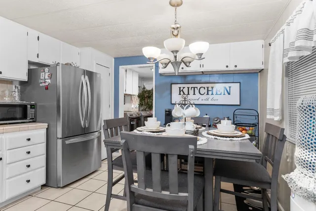 a view of a dining room with furniture a chandelier and wooden floor