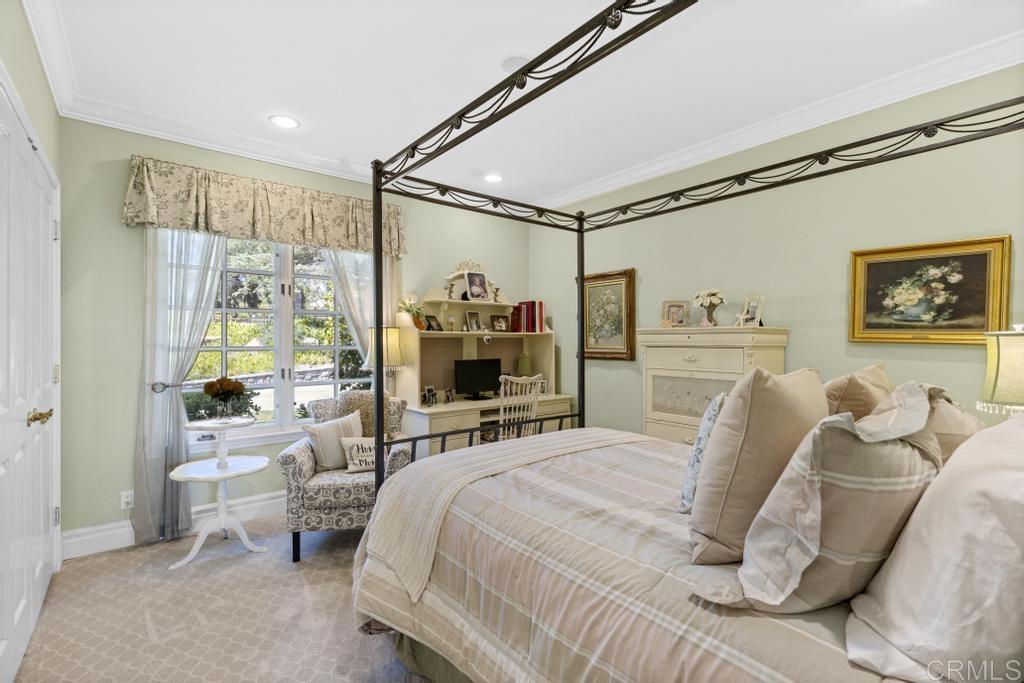 27 Shady Hill Lane Fallbrook, CA 92028 - Photo 30 of 75 a bedroom with a bed couch and a large mirror next to a window