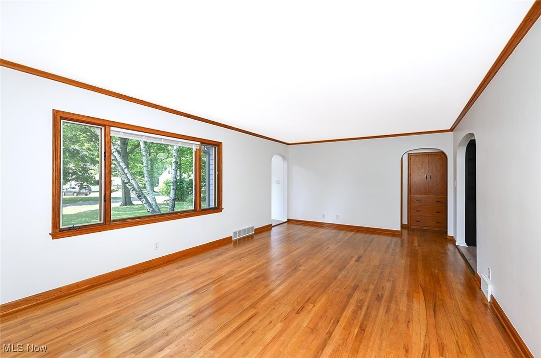 351 North Messner Road Akron, OH 44319 - Photo 11 of 44 *LARGE LIVING ROOM W/SHINY HARDWOOD FLOORS, FEATURE WALL, CROWN MOLDING, STONE SURROUND FIREPLACE AND TILED HEARTH. ARCHED ENTRYWAY TO THE EAT IN KITCHEN AND BEDROOMS ~