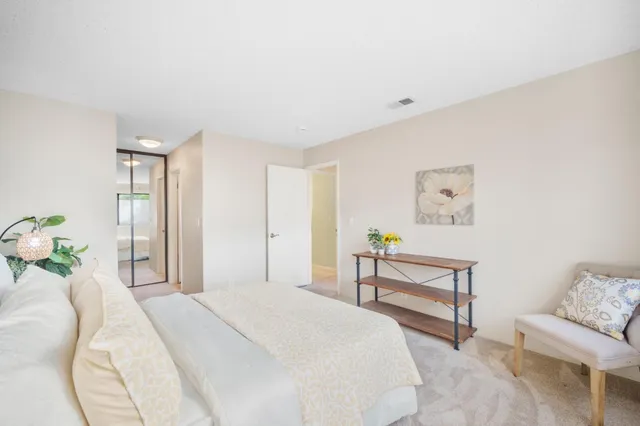 a bedroom with a bed and a couch