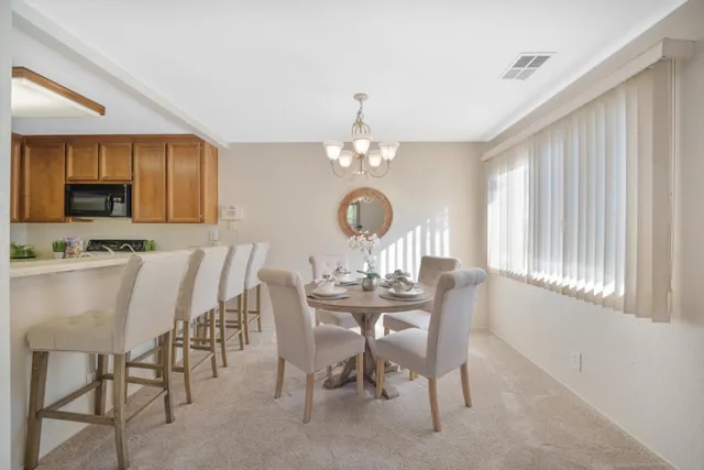 a view of a dining room with furniture and chandelier