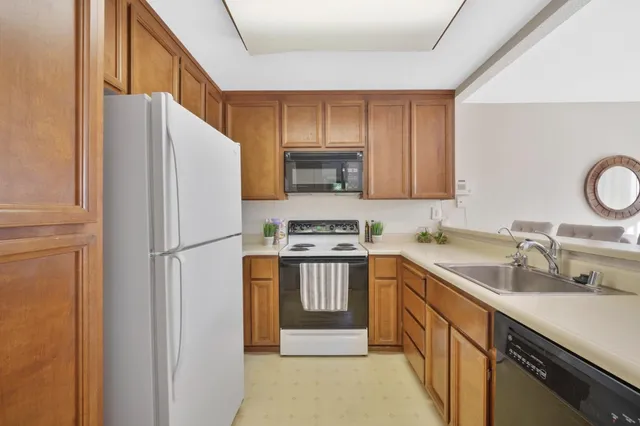 a kitchen with a refrigerator sink and stove