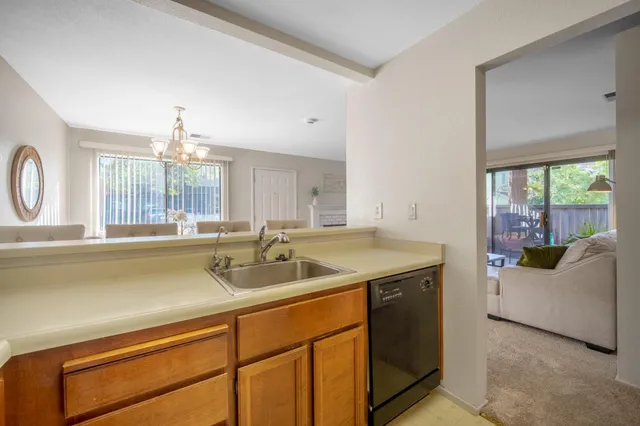 a kitchen with a sink and a large window