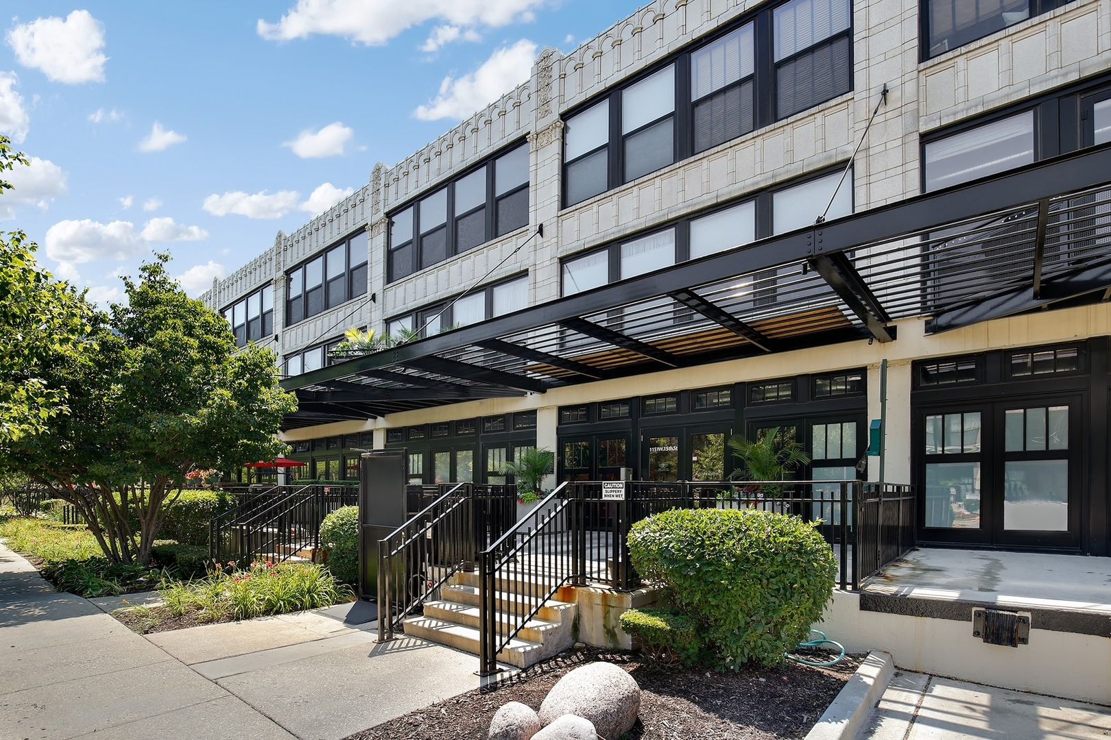 1111 West 15th Street, Unit 113 Chicago, IL 60608 - Photo 2 of 34 a view of a chair and tables in the patio