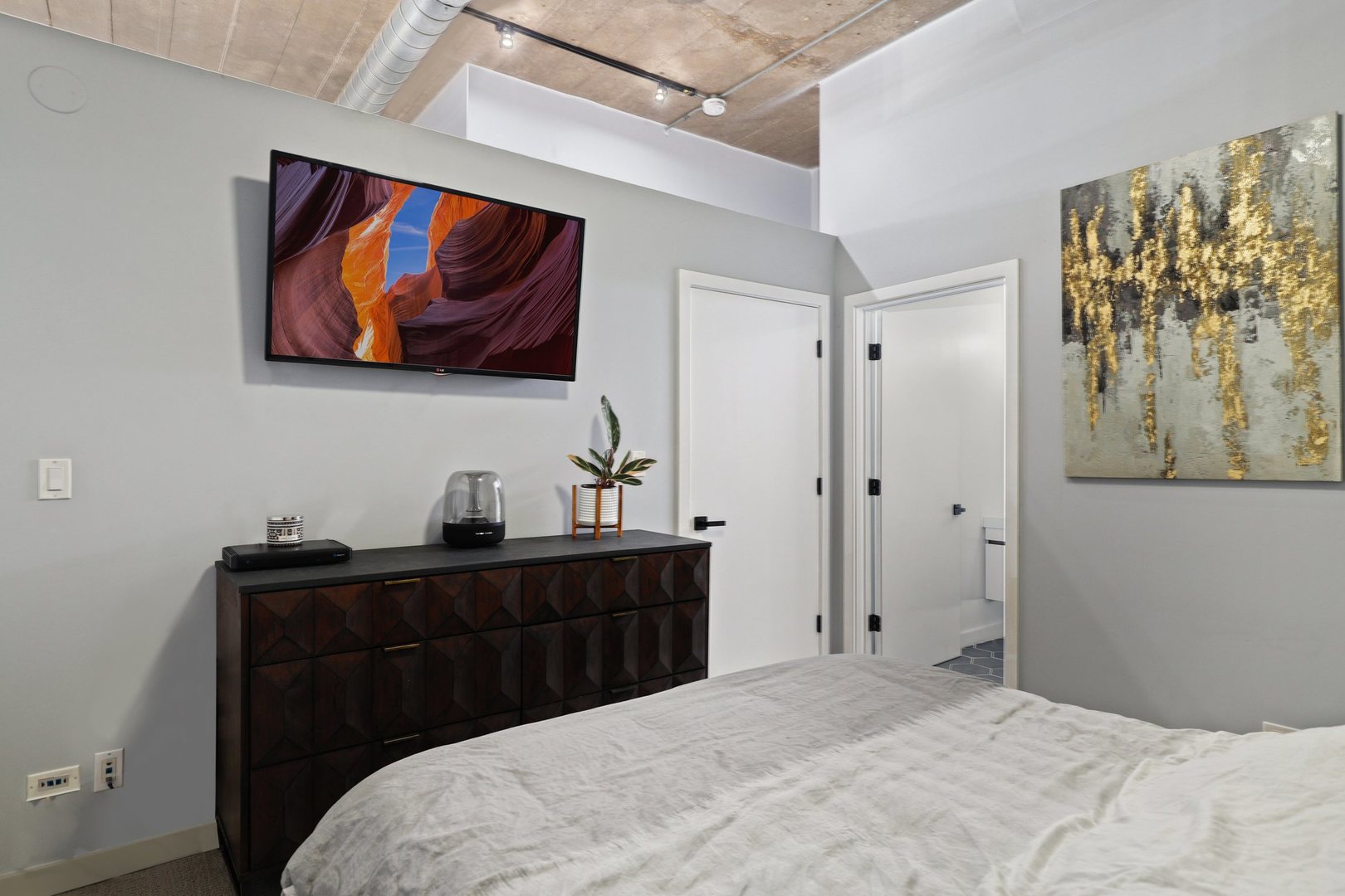 1111 West 15th Street, Unit 113 Chicago, IL 60608 - Photo 15 of 34 a bedroom with a bed and a dresser