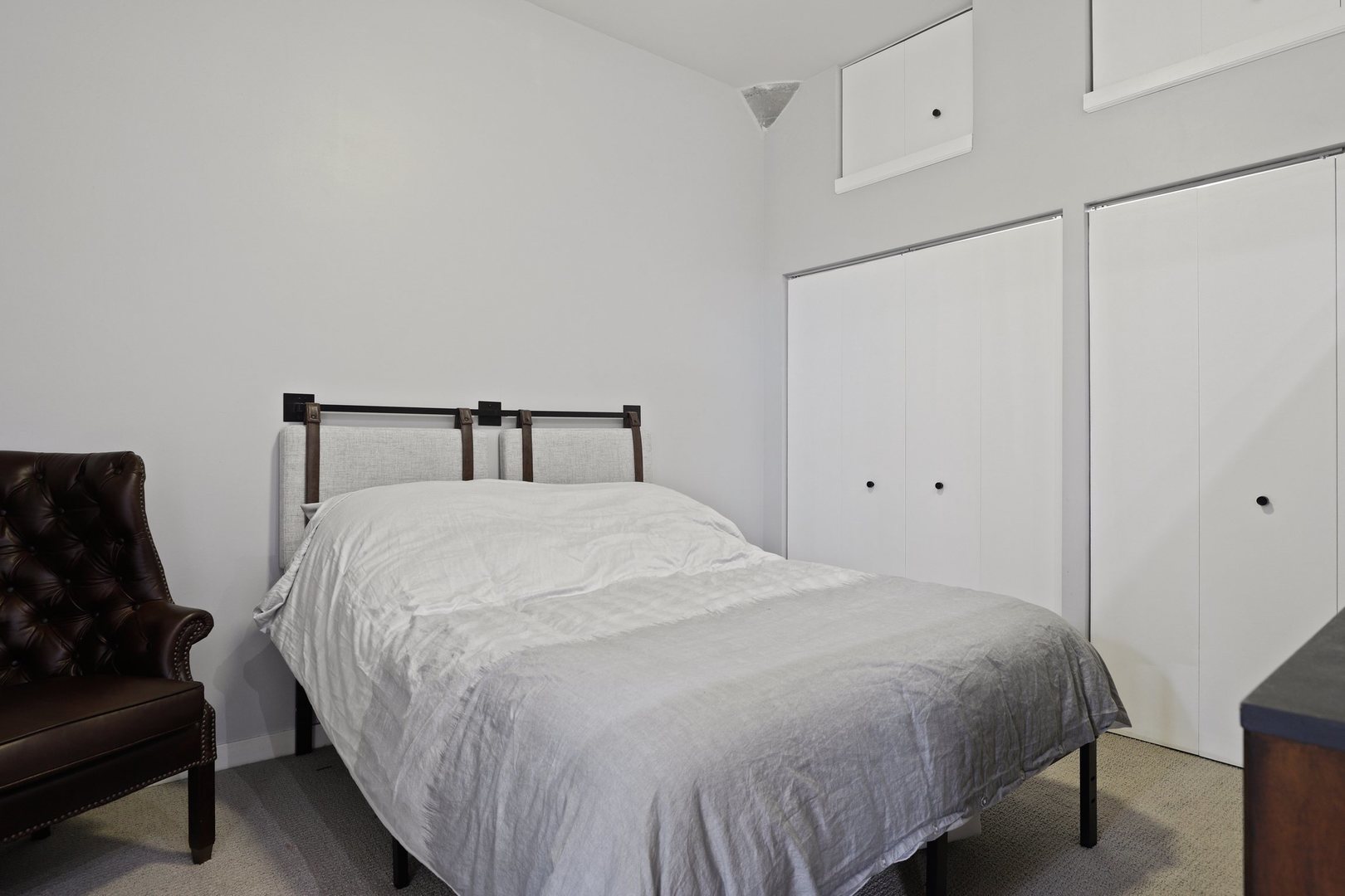 1111 West 15th Street, Unit 113 Chicago, IL 60608 - Photo 16 of 34 a bedroom with a bed and a dresser