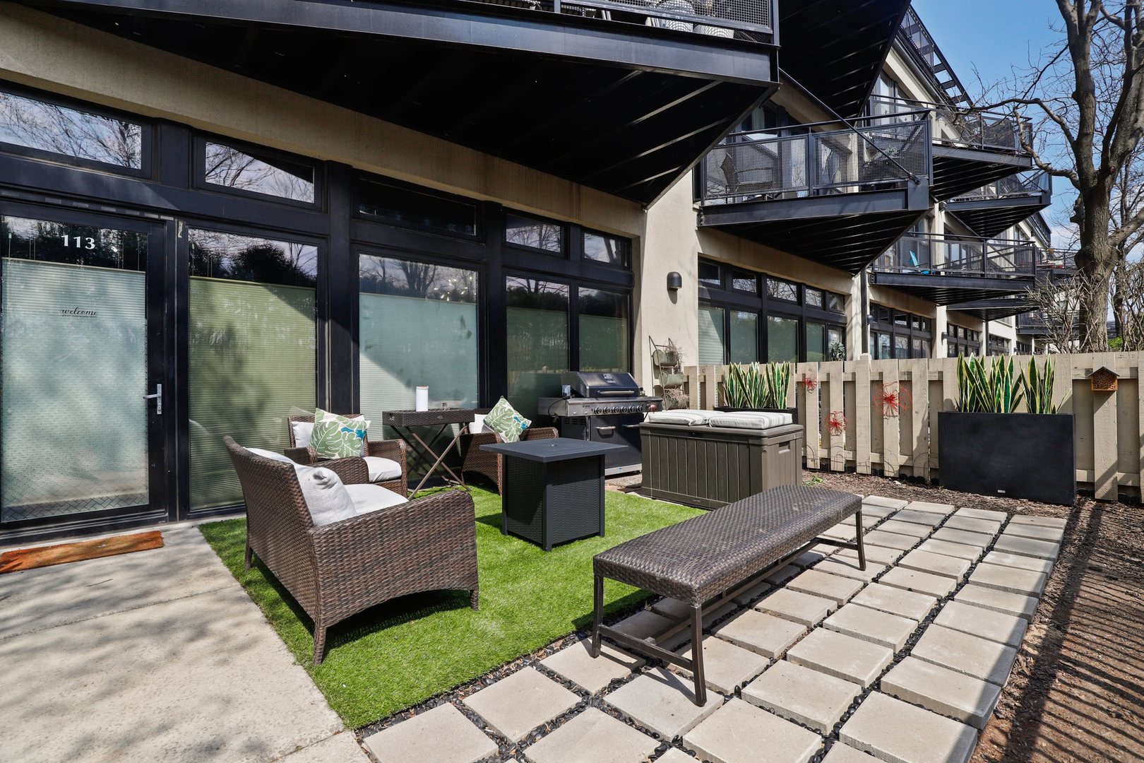 1111 West 15th Street, Unit 113 Chicago, IL 60608 - Photo 26 of 34 a living room with furniture and a potted plant