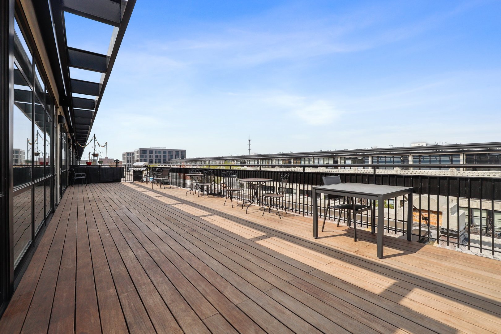 1111 West 15th Street, Unit 113 Chicago, IL 60608 - Photo 32 of 34 a view of balcony with wooden floor and city view