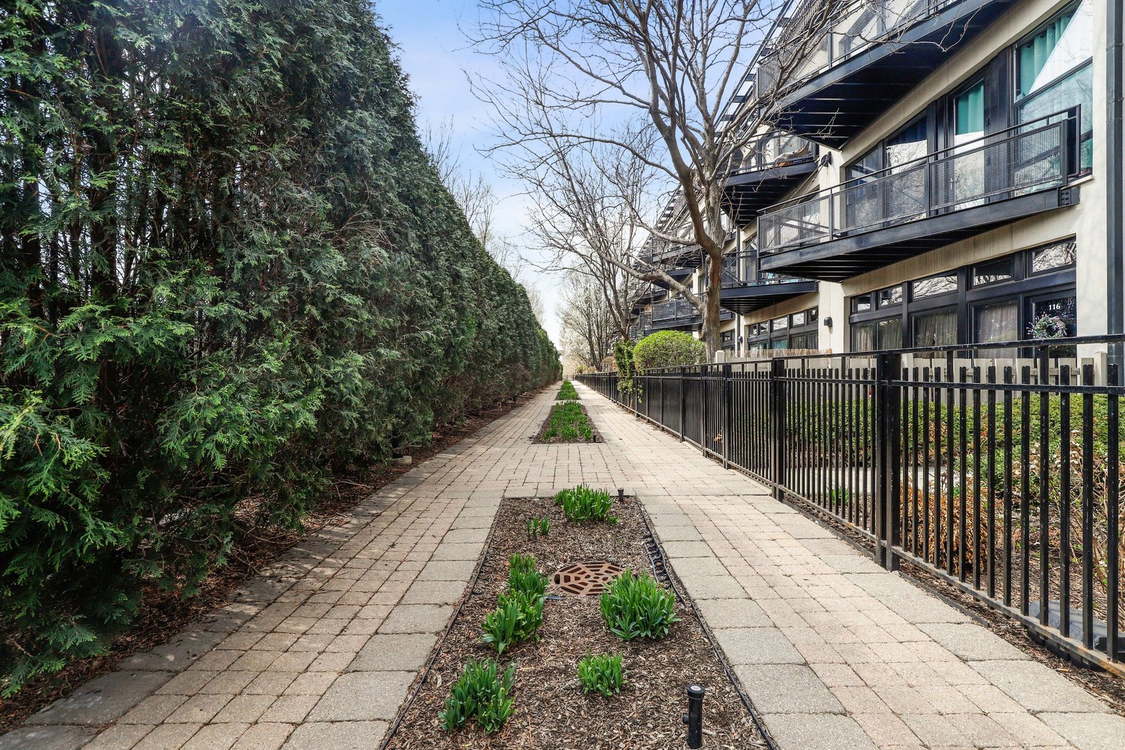 1111 West 15th Street, Unit 113 Chicago, IL 60608 - Photo 34 of 34 a view of a pathway with a wrought fence