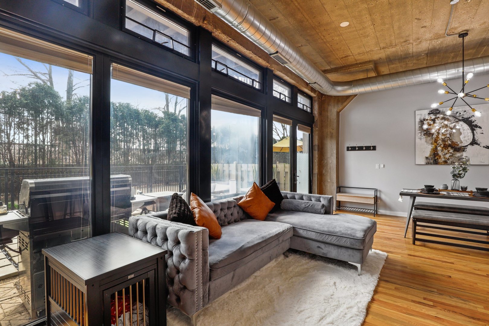 1111 West 15th Street, Unit 113 Chicago, IL 60608 - Photo 6 of 34 a living room with furniture and a floor to ceiling window