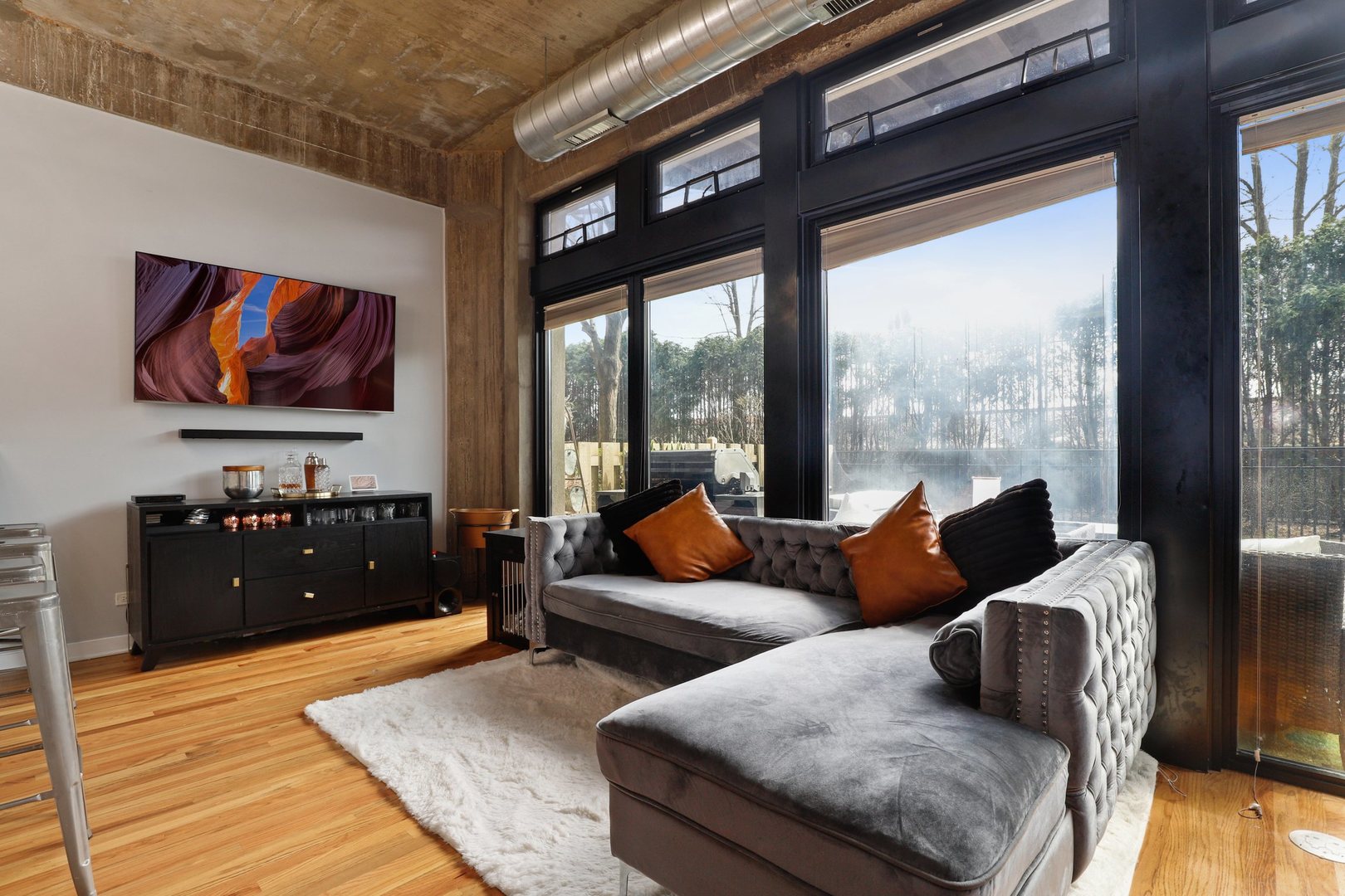 1111 West 15th Street, Unit 113 Chicago, IL 60608 - Photo 7 of 34 a living room with furniture and a flat screen tv