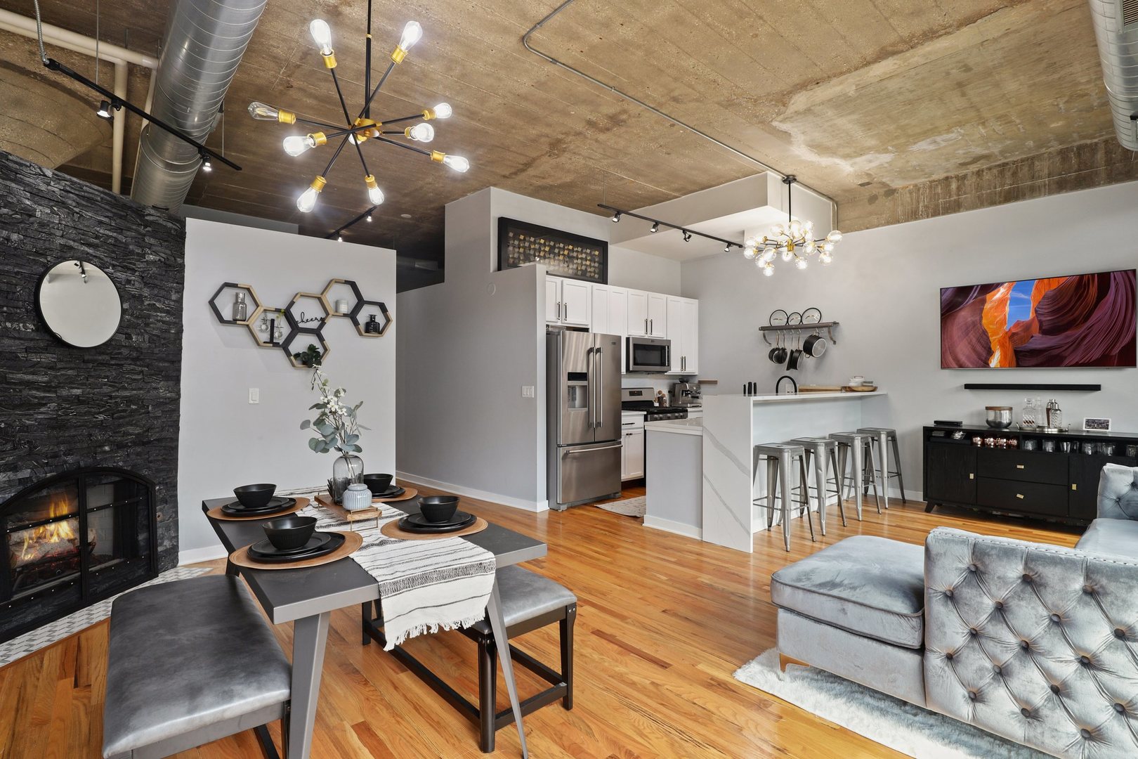 1111 West 15th Street, Unit 113 Chicago, IL 60608 - Photo 9 of 34 a living room with furniture and flat screen tv