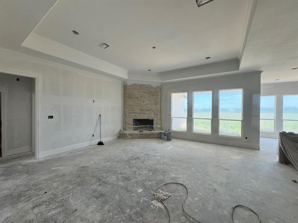 173 Willow Branch Road McGregor, TX 76657 - Photo 12 of 18 a view of an empty room with a fireplace and a window
