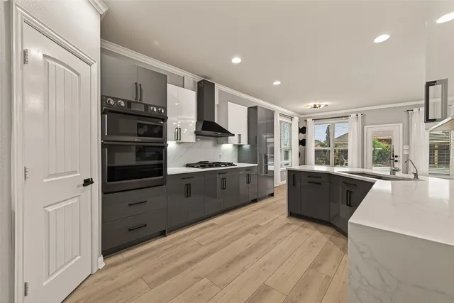 a kitchen with stainless steel appliances kitchen island granite countertop a refrigerator and a stove top oven