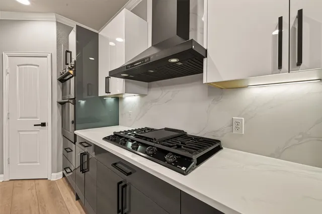 a kitchen with granite countertop a stove and a refrigerator
