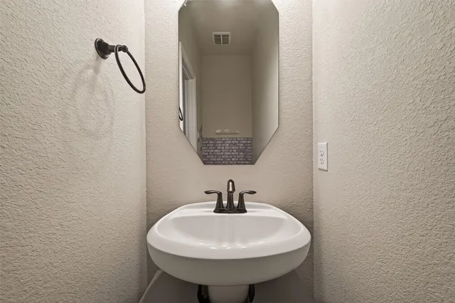 a large kitchen with kitchen island wooden floors and stainless steel appliances