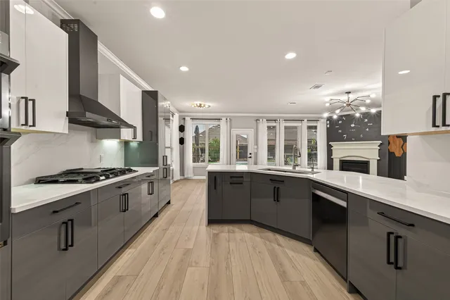 a large kitchen with stainless steel appliances granite countertop a stove and a sink
