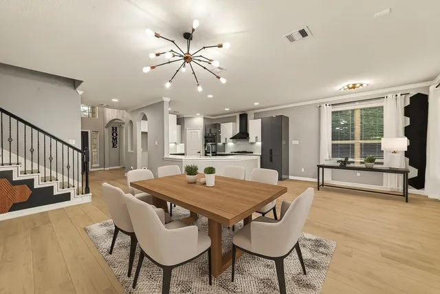 a view of a dining room with furniture and wooden floor