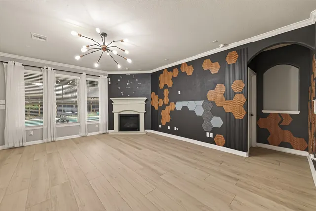 a view of an empty room with a fireplace and a window