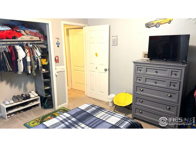 a bedroom with a bed and a painting on the wall