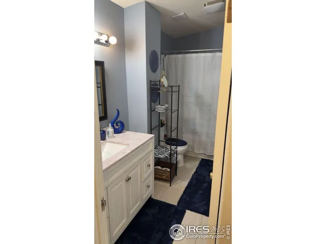 a living room with furniture and a lamp