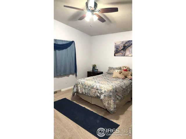 a bedroom with a bed and a painting on the wall