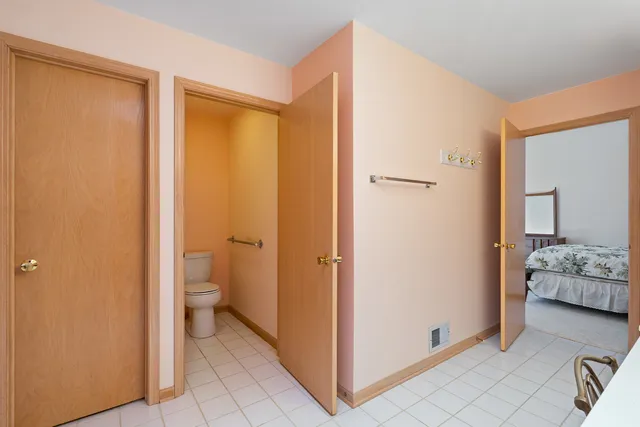 a bathroom with a granite countertop sink a toilet and shower