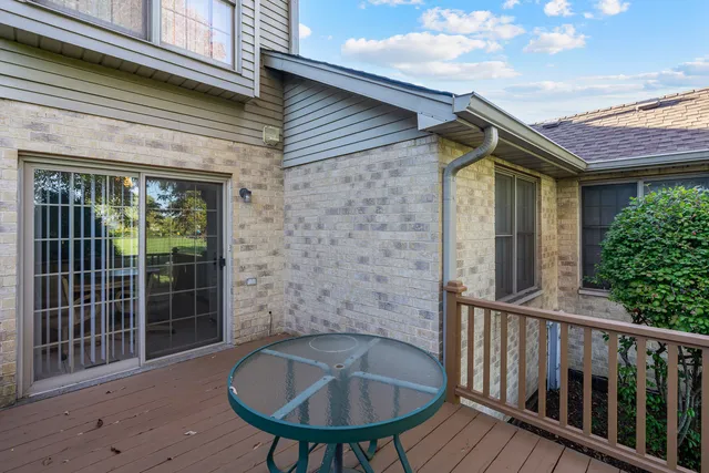 a brick house with table and chairs