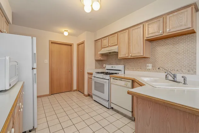 a kitchen with a sink cabinets and a window