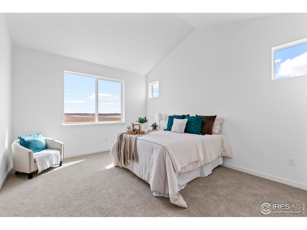 797 Muturu Road Johnstown, CO 80534 - Photo 14 of 26 a bedroom with a bed table and window